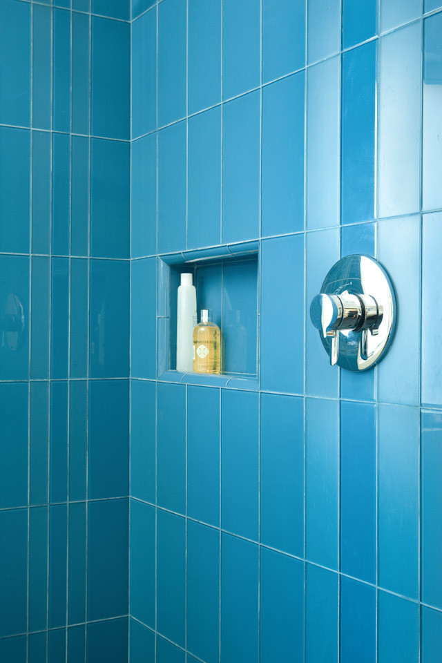 Corner shower - mid-sized modern kids' blue tile and glass tile ceramic tile corner shower idea in Los Angeles with an undermount sink, flat-panel cabinets, brown cabinets, quartz countertops, a two-piece toilet and blue walls