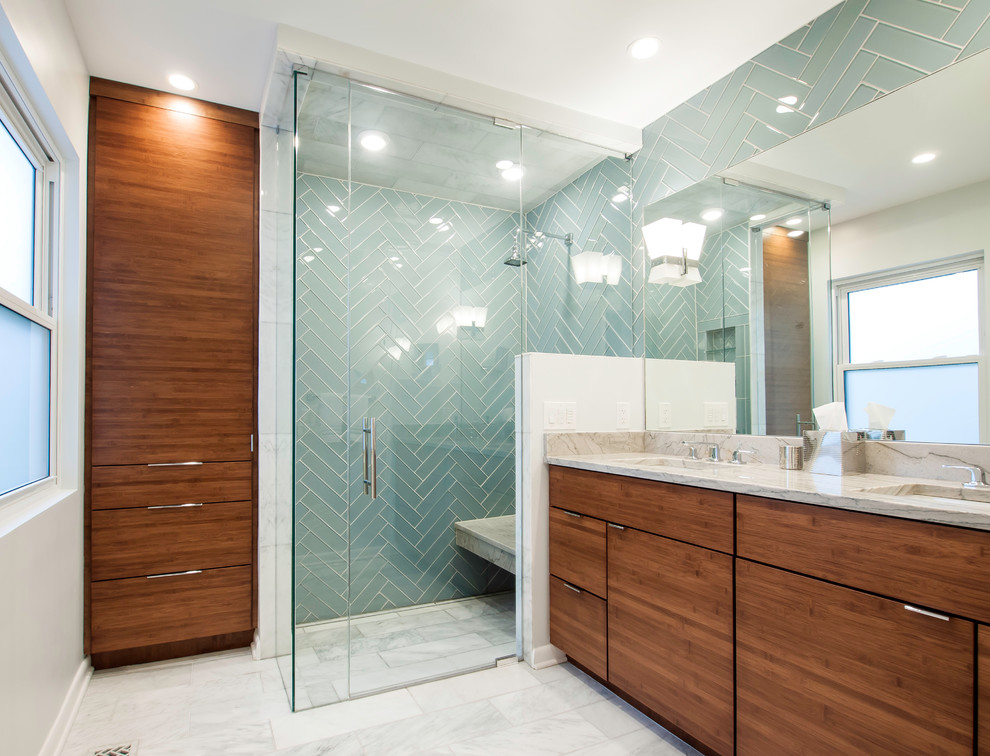 Walk-in shower - small mid-century modern master green tile and glass tile marble floor and white floor walk-in shower idea in Cincinnati with flat-panel cabinets, dark wood cabinets, a two-piece toilet, gray walls, an undermount sink and a hinged shower door