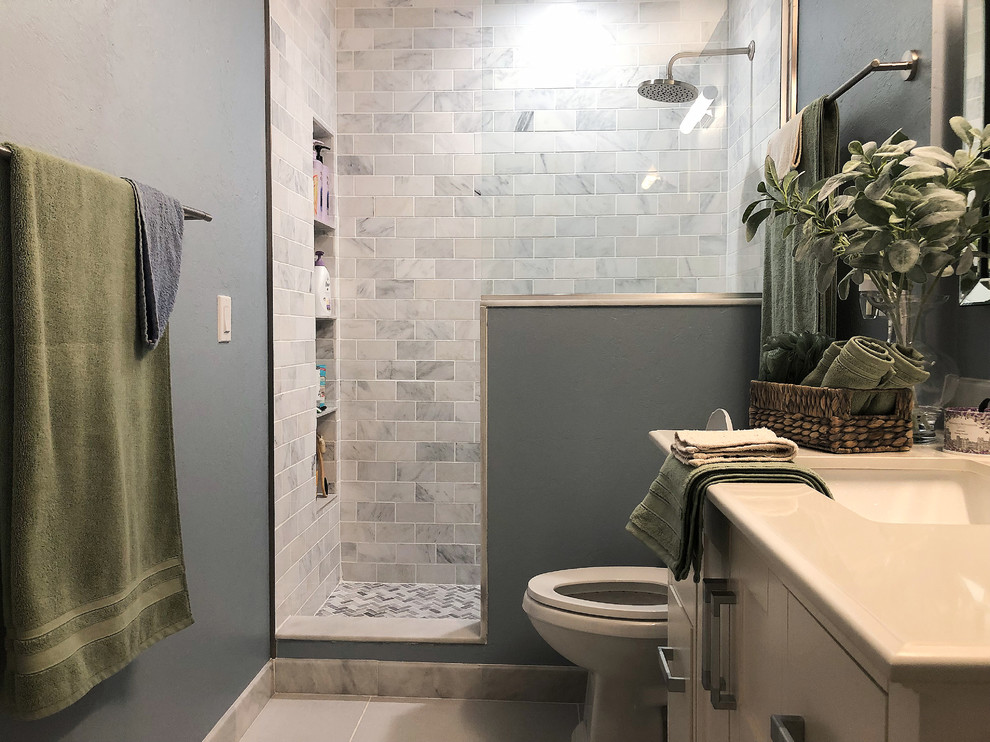 Example of a huge trendy 3/4 multicolored tile and marble tile ceramic tile and gray floor bathroom design in Miami with shaker cabinets, white cabinets, a one-piece toilet, blue walls, an integrated sink, quartz countertops and white countertops