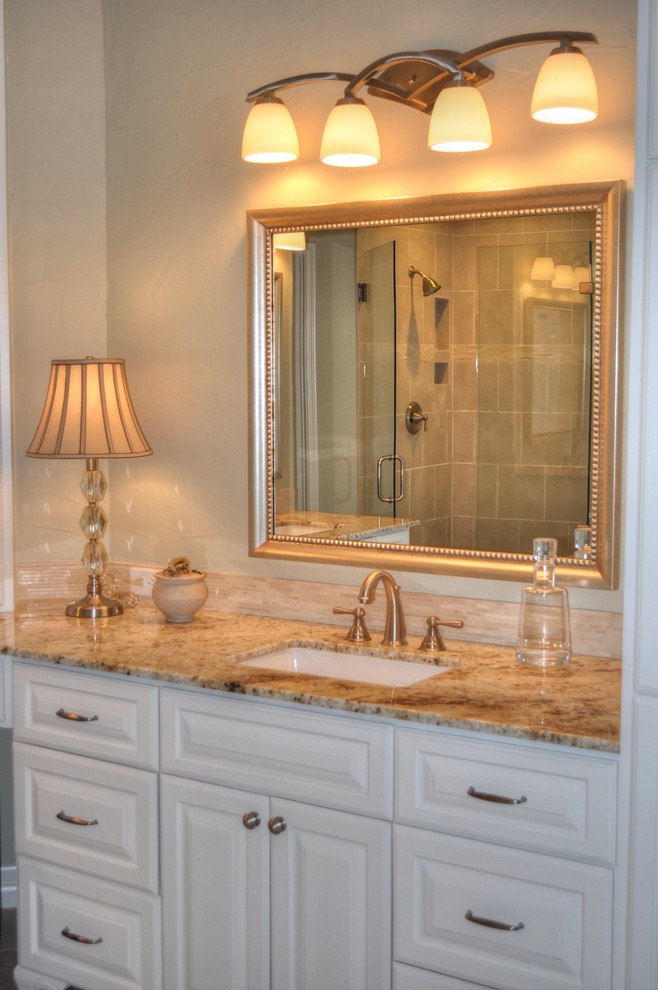 Large elegant master beige tile and ceramic tile ceramic tile bathroom photo in Houston with a drop-in sink, raised-panel cabinets, white cabinets, granite countertops and beige walls