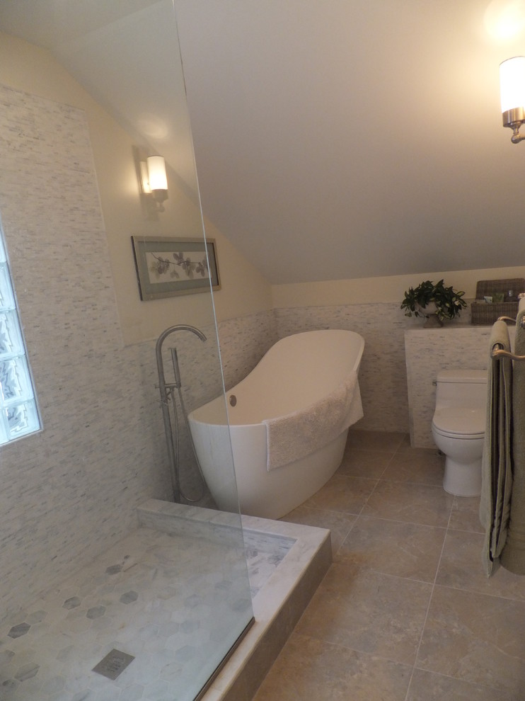 Photo of a medium sized traditional ensuite bathroom in Orange County with flat-panel cabinets, white cabinets, a freestanding bath, a walk-in shower, a one-piece toilet, grey tiles, white tiles, matchstick tiles, white walls, ceramic flooring, a vessel sink, solid surface worktops, beige floors and a hinged door.