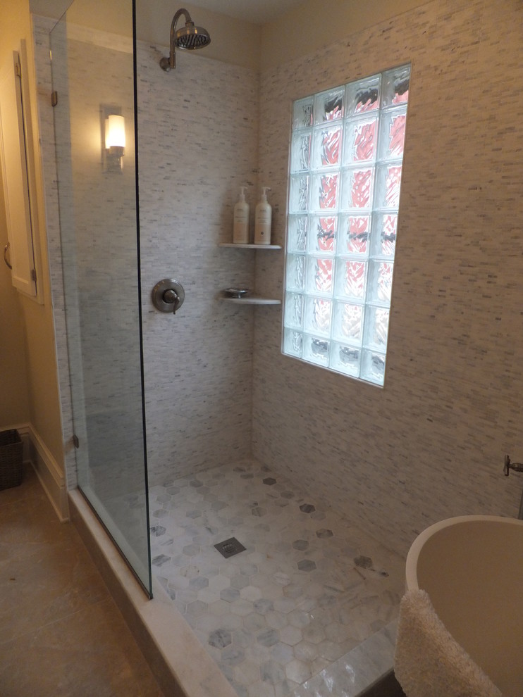 Bathroom - mid-sized transitional master gray tile, white tile and matchstick tile ceramic tile and beige floor bathroom idea in Orange County with flat-panel cabinets, white cabinets, a one-piece toilet, white walls, a vessel sink and solid surface countertops