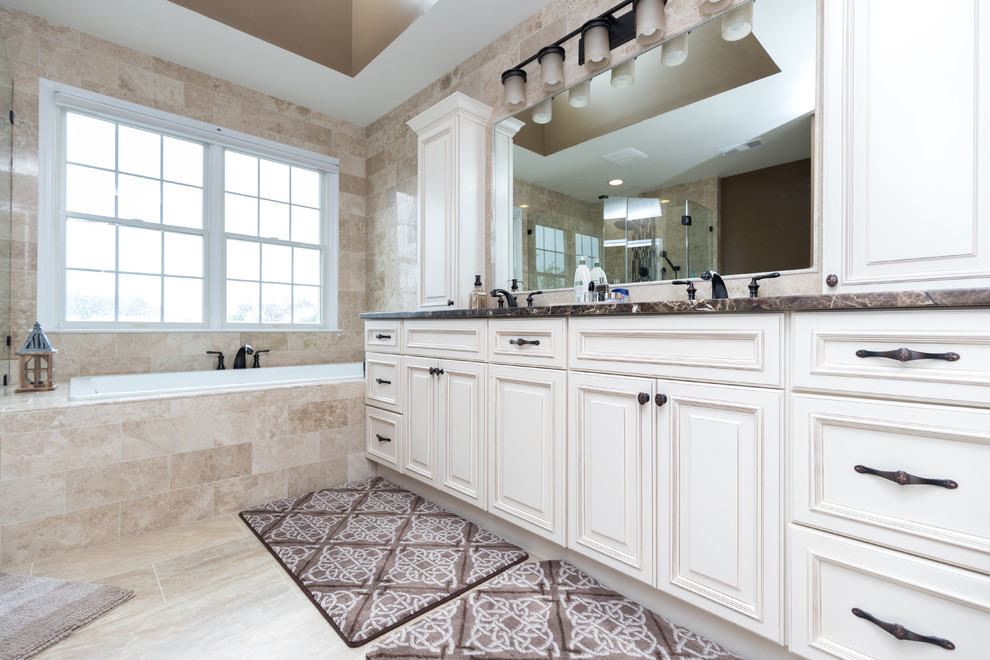 Bathroom - mid-sized traditional master brown tile and stone tile porcelain tile and beige floor bathroom idea in DC Metro with recessed-panel cabinets, white cabinets, an undermount sink, granite countertops and a hinged shower door