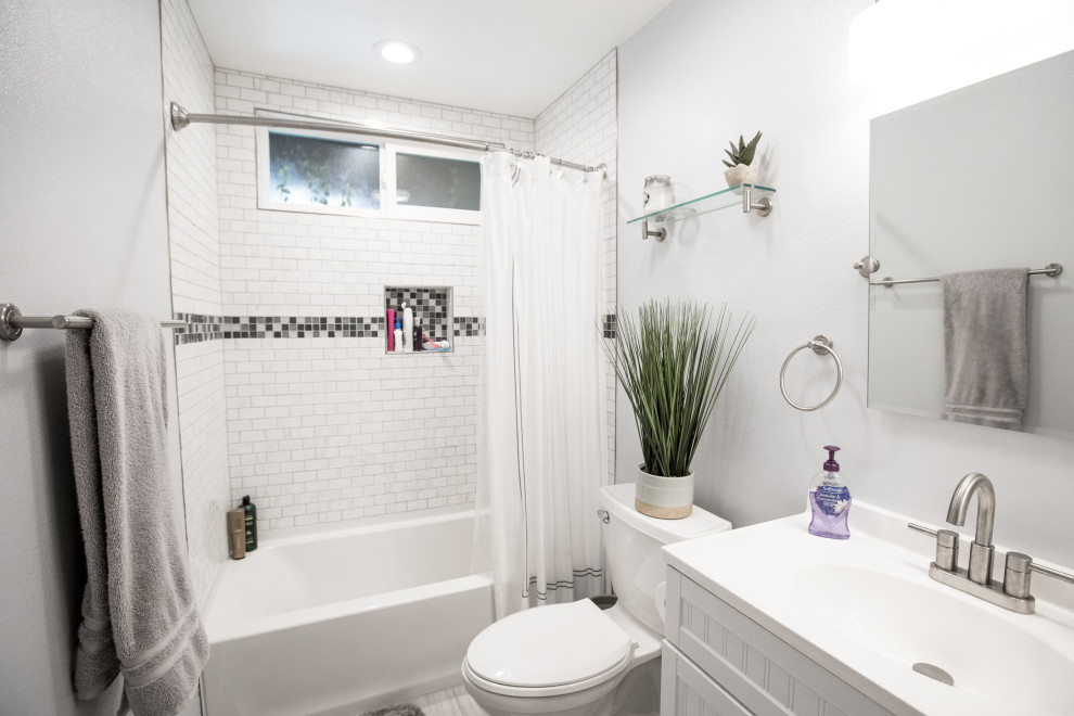 Design ideas for a medium sized contemporary shower room bathroom in Los Angeles with grey cabinets, a shower/bath combination, a one-piece toilet, white tiles, ceramic tiles, white walls, granite worktops, grey floors, a shower curtain and grey worktops.
