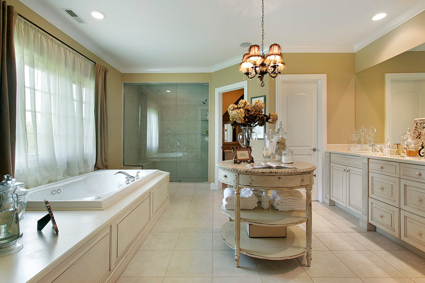 Photo of a large traditional ensuite bathroom in New York with beaded cabinets, beige cabinets, a built-in bath, an alcove shower, porcelain flooring, a submerged sink, engineered stone worktops, beige floors, a hinged door and beige worktops.