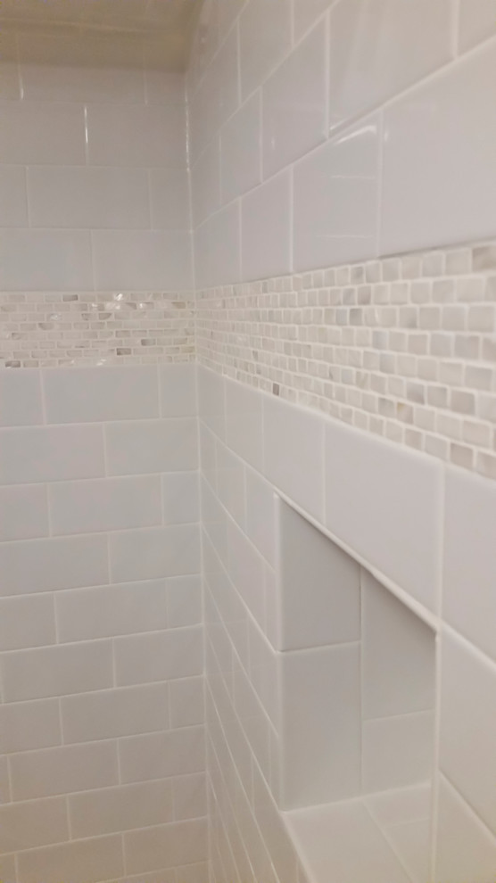 Example of a small trendy master white tile light wood floor tub/shower combo design in Chicago with an undermount sink, beige cabinets, granite countertops and white walls