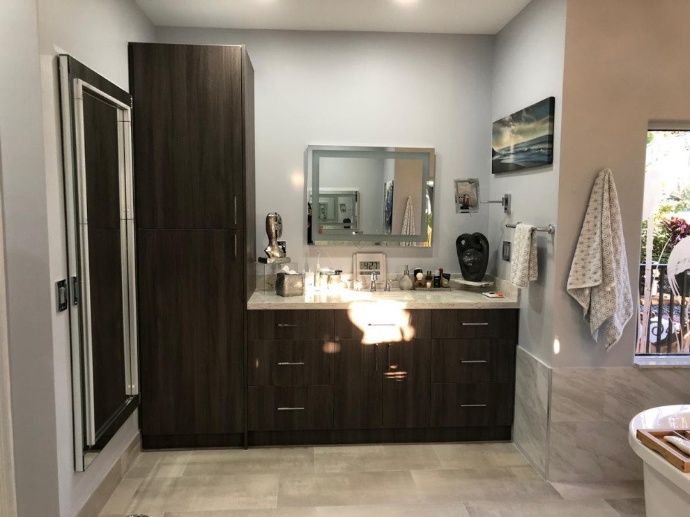 Large minimalist master ceramic tile porcelain tile, gray floor and double-sink bathroom photo in Miami with flat-panel cabinets, brown cabinets, a bidet, an undermount sink, quartzite countertops, a hinged shower door, beige countertops and a built-in vanity