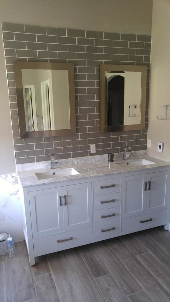 Photo of a medium sized classic bathroom in Denver with white cabinets, brown tiles, metro tiles, beige walls, dark hardwood flooring, a submerged sink, granite worktops, brown floors, white worktops and shaker cabinets.