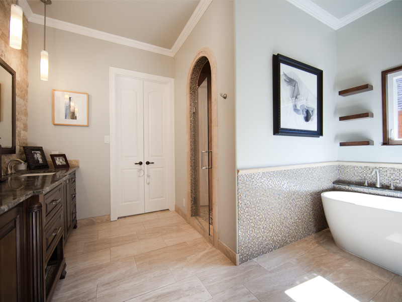 Bathroom - mid-sized contemporary master beige tile and stone tile travertine floor and beige floor bathroom idea in Dallas with an undermount sink, furniture-like cabinets, dark wood cabinets, granite countertops, a two-piece toilet, gray walls and a hinged shower door