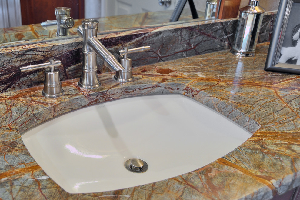 Example of a mid-sized eclectic master multicolored tile and porcelain tile porcelain tile bathroom design in Philadelphia with an undermount sink, raised-panel cabinets, dark wood cabinets, marble countertops, a two-piece toilet and brown walls