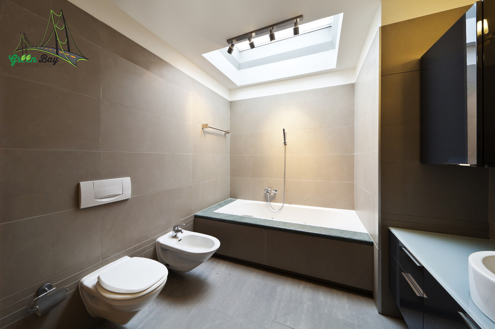 Medium sized contemporary ensuite bathroom in San Francisco with flat-panel cabinets, black cabinets, a built-in bath, a bidet, grey tiles, beige walls, painted wood flooring, a vessel sink, glass worktops and a walk-in shower.