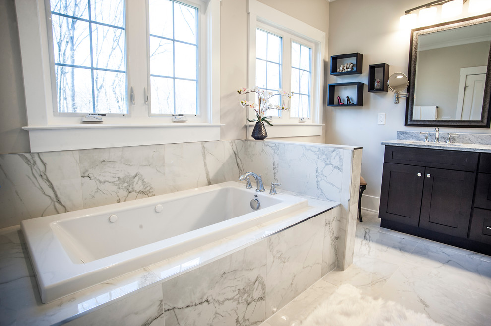 Design ideas for a medium sized traditional ensuite bathroom in DC Metro with shaker cabinets, dark wood cabinets, a hot tub, a walk-in shower, a one-piece toilet, white tiles, porcelain tiles, beige walls, porcelain flooring, a built-in sink and limestone worktops.