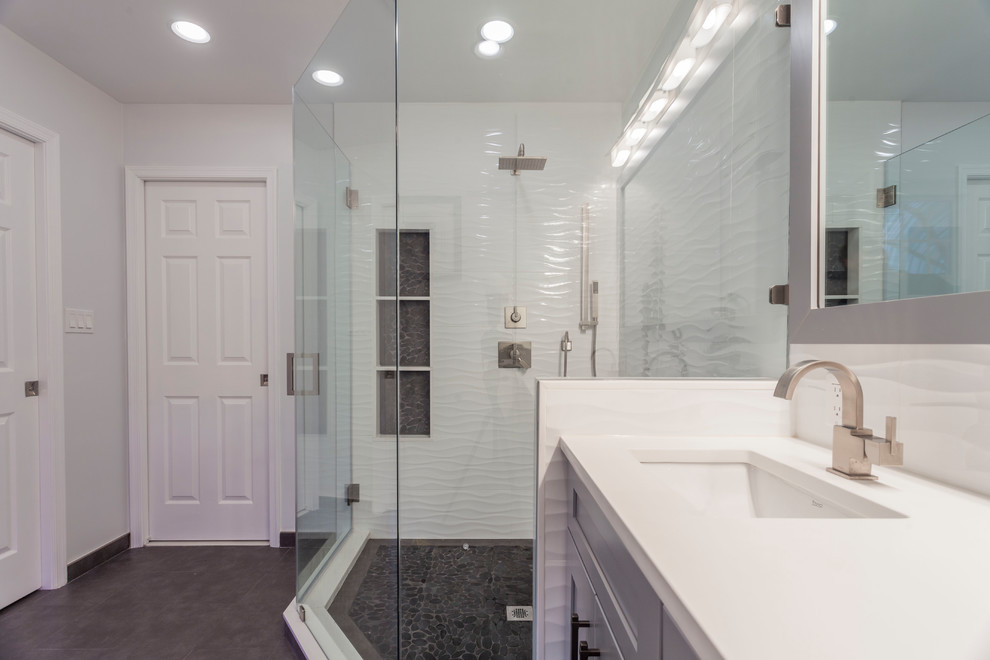 This is an example of a large classic ensuite bathroom in DC Metro with grey cabinets, a corner shower, a one-piece toilet, white tiles, ceramic flooring, a submerged sink, grey floors, a sliding door, shaker cabinets, porcelain tiles, grey walls and engineered stone worktops.