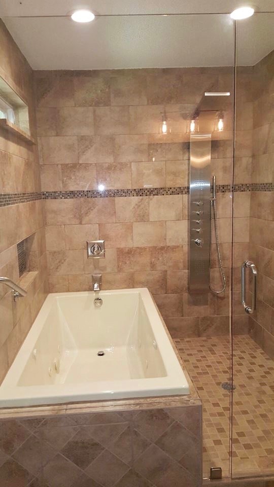 Example of a transitional beige tile and ceramic tile porcelain tile and beige floor bathroom design in Atlanta with white cabinets, beige walls, solid surface countertops and a hinged shower door