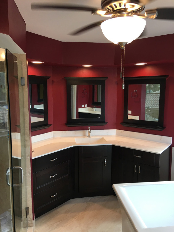 Inspiration for a medium sized modern ensuite bathroom in Miami with flat-panel cabinets, black cabinets, a corner shower, red walls, porcelain flooring, an integrated sink, engineered stone worktops, beige floors and a hinged door.
