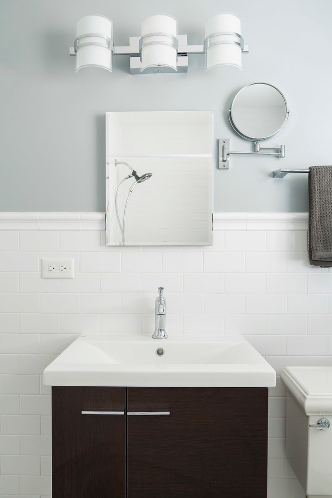 Exempel på ett klassiskt badrum, med skåp i mörkt trä, en dusch/badkar-kombination, en toalettstol med separat cisternkåpa, vit kakel, tunnelbanekakel, blå väggar, ett integrerad handfat och dusch med duschdraperi