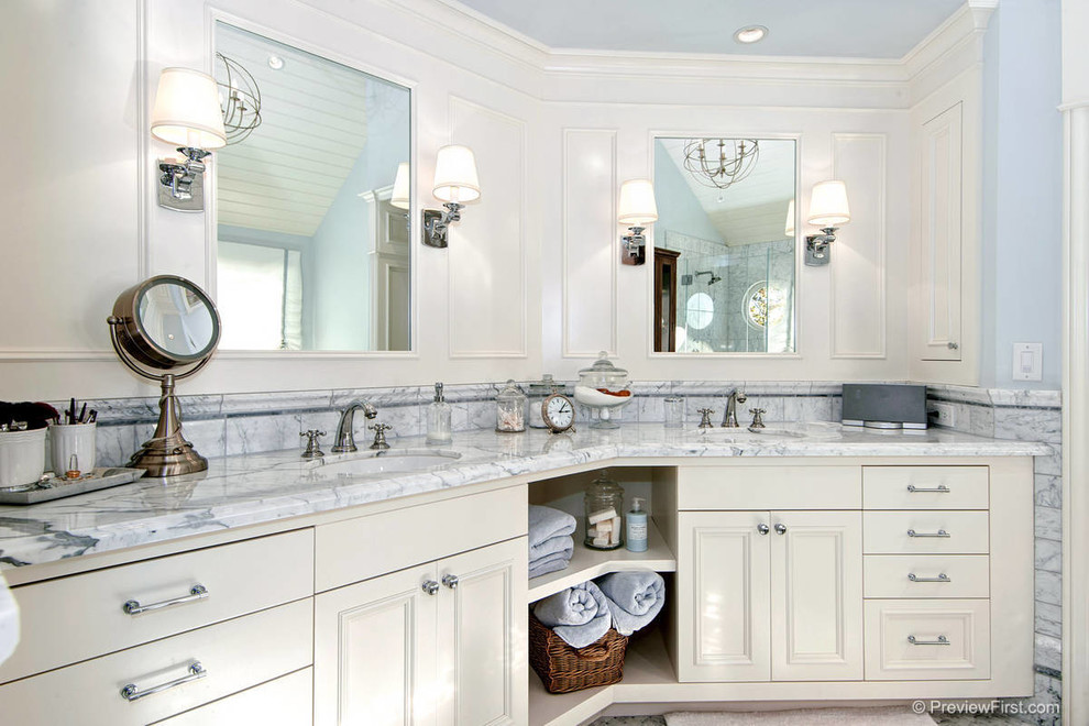 Idee per una stanza da bagno stile marino con lavabo sottopiano, ante bianche e top in marmo