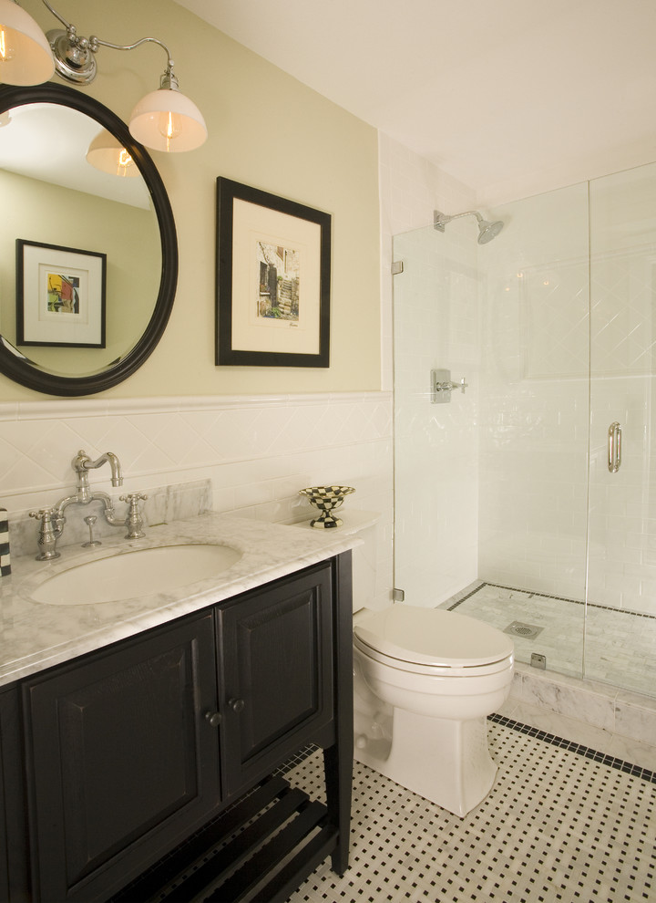 This is an example of a classic half tiled bathroom in Seattle with mosaic tiles and feature lighting.
