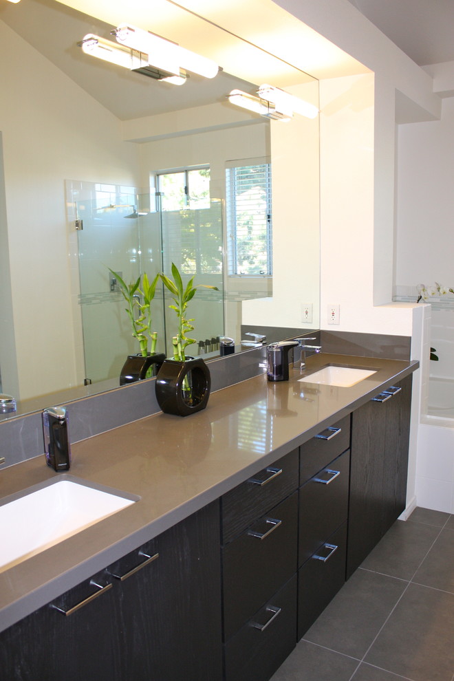 Mid-sized trendy master gray tile and porcelain tile porcelain tile bathroom photo in San Diego with flat-panel cabinets, black cabinets, quartz countertops, a one-piece toilet, an undermount sink and white walls
