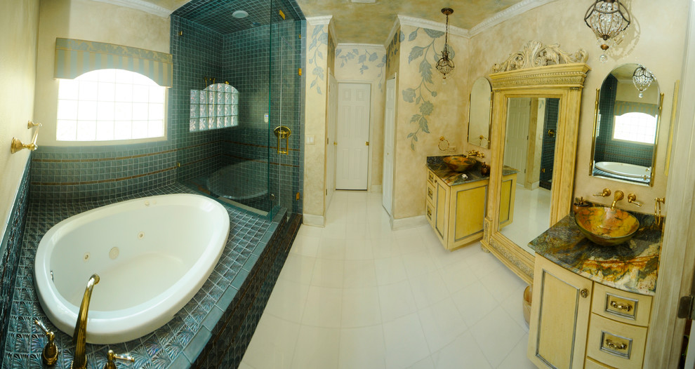 Inspiration for a large victorian ensuite bathroom in Tampa with recessed-panel cabinets, yellow cabinets, a built-in bath, an alcove shower, a two-piece toilet, brown tiles, porcelain tiles, yellow walls, porcelain flooring, a vessel sink, marble worktops, white floors and a hinged door.