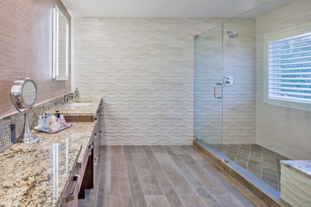 Doorless shower - mid-sized contemporary master beige tile and porcelain tile porcelain tile doorless shower idea in Miami with an undermount sink, flat-panel cabinets, light wood cabinets, granite countertops, a one-piece toilet and beige walls