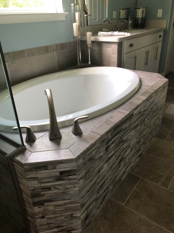 Inspiration for a mid-sized contemporary master gray tile and matchstick tile travertine floor and beige floor bathroom remodel in Orlando with shaker cabinets, white cabinets, blue walls, an undermount sink, granite countertops, a hinged shower door and beige countertops