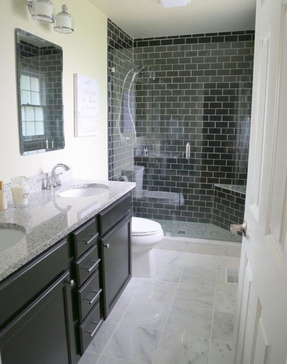 Inspiration for a mid-sized timeless 3/4 black tile and subway tile marble floor and white floor alcove shower remodel in Los Angeles with recessed-panel cabinets, black cabinets, a two-piece toilet, beige walls, an undermount sink, limestone countertops, a hinged shower door and gray countertops