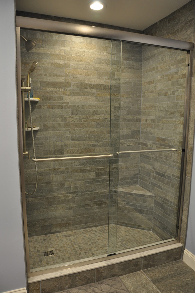 Alcove shower - mid-sized transitional 3/4 multicolored tile and porcelain tile porcelain tile alcove shower idea in New York with an undermount sink, shaker cabinets, dark wood cabinets, marble countertops, a two-piece toilet and blue walls