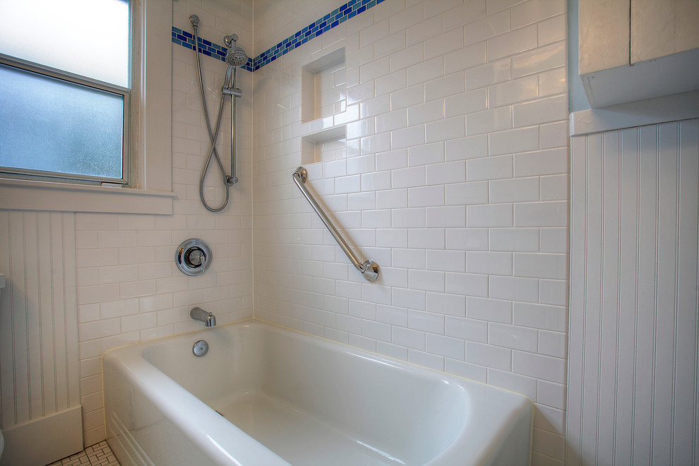 Photo of a small classic bathroom in Seattle with a corner bath, a shower/bath combination, white tiles, porcelain tiles, blue walls and porcelain flooring.