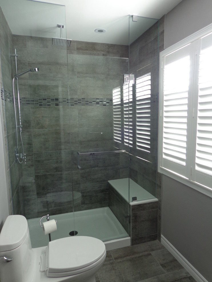 This is an example of a medium sized contemporary ensuite bathroom in Toronto with a submerged sink, shaker cabinets, dark wood cabinets, engineered stone worktops, a one-piece toilet, grey tiles, porcelain tiles, grey walls and porcelain flooring.