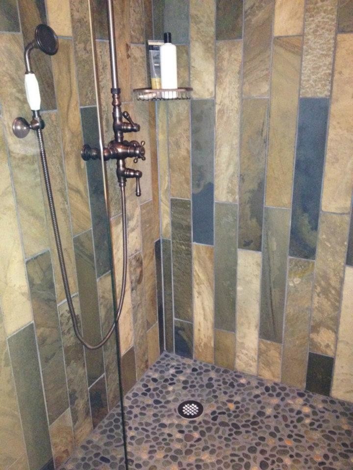 Small rustic shower room bathroom in Toronto with an alcove shower, a one-piece toilet, multi-coloured tiles and pebble tiles.