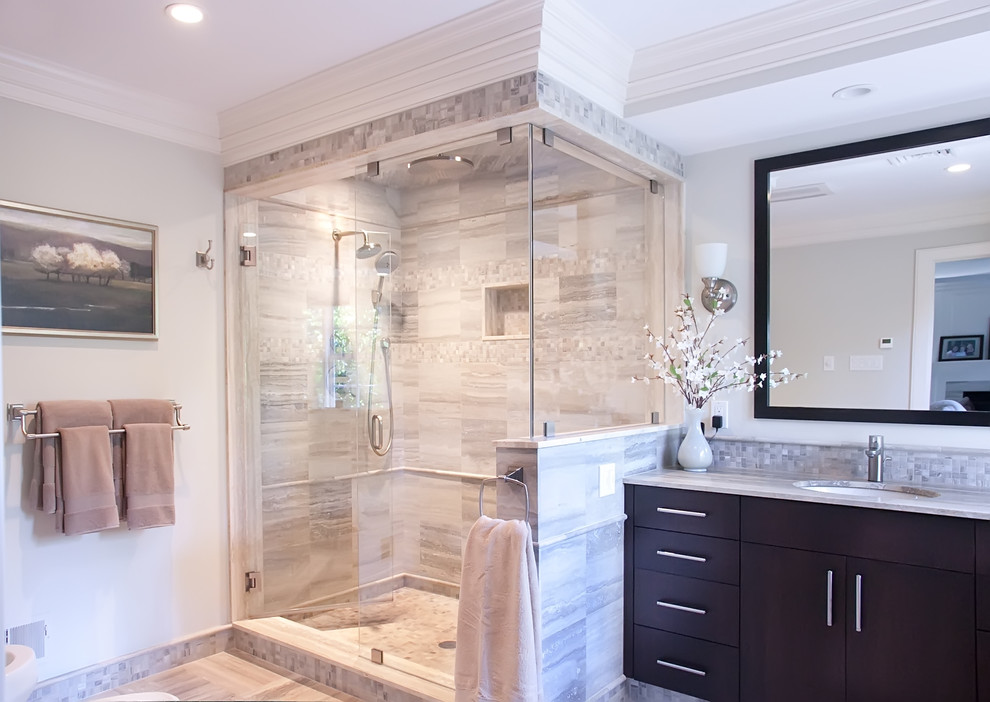 Example of a classic multicolored tile and stone tile corner shower design in Philadelphia with an undermount sink, flat-panel cabinets, dark wood cabinets, granite countertops, a two-piece toilet and white walls