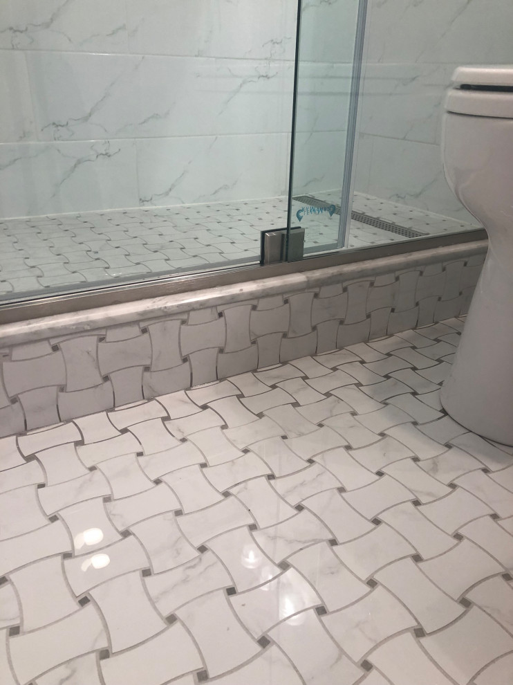 Bathroom - small transitional 3/4 gray tile and marble tile porcelain tile, multicolored floor and single-sink bathroom idea in Chicago with shaker cabinets, white cabinets, a two-piece toilet, white walls, an undermount sink, white countertops, a niche and a built-in vanity