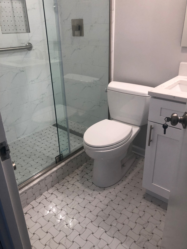 Design ideas for a small classic shower room bathroom in Chicago with shaker cabinets, white cabinets, an alcove shower, a two-piece toilet, grey tiles, marble tiles, white walls, porcelain flooring, a submerged sink, multi-coloured floors, a sliding door, white worktops, a wall niche, a single sink and a built in vanity unit.