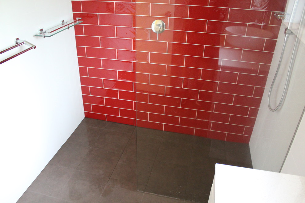 Modern inredning av ett litet en-suite badrum, med öppna hyllor, vita skåp, en öppen dusch, röd kakel, keramikplattor, vita väggar, klinkergolv i porslin, ett fristående handfat, bänkskiva i akrylsten, brunt golv och med dusch som är öppen