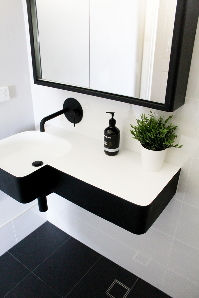 This is an example of a small modern shower room bathroom in Perth with open cabinets, black cabinets, a walk-in shower, multi-coloured tiles, metro tiles, multi-coloured walls, porcelain flooring, a pedestal sink, solid surface worktops, black floors, an open shower and white worktops.
