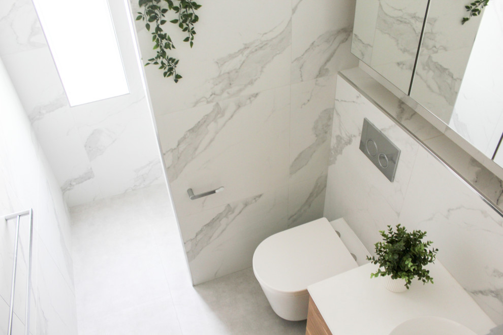 Example of a small minimalist 3/4 white tile and porcelain tile porcelain tile, gray floor and single-sink bathroom design in Perth with flat-panel cabinets, distressed cabinets, a wall-mount toilet, white walls, a vessel sink, quartz countertops, white countertops and a floating vanity