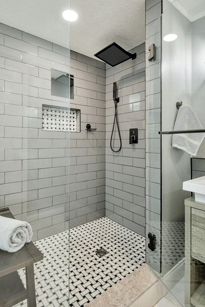 Стильный дизайн: главная ванная комната среднего размера в современном стиле с плоскими фасадами, светлыми деревянными фасадами, угловым душем, унитазом-моноблоком, серой плиткой, плиткой кабанчик, серыми стенами, полом из керамогранита, настольной раковиной, столешницей из талькохлорита, белым полом, душем с распашными дверями, белой столешницей, нишей, тумбой под одну раковину и напольной тумбой - последний тренд