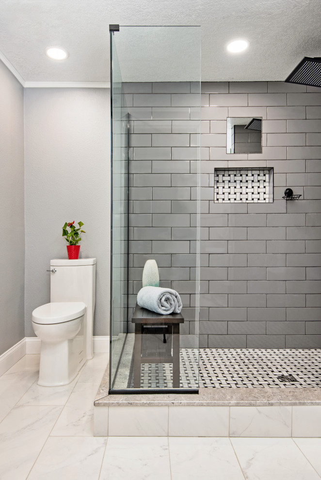 Example of a mid-sized trendy master gray tile and subway tile porcelain tile, white floor and single-sink corner shower design in Tampa with flat-panel cabinets, light wood cabinets, a one-piece toilet, gray walls, a vessel sink, soapstone countertops, a hinged shower door, white countertops, a niche and a freestanding vanity