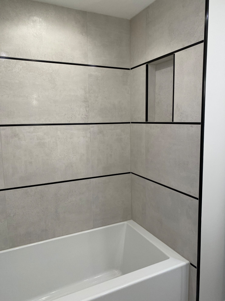 Photo of a medium sized modern shower room bathroom in New York with flat-panel cabinets, distressed cabinets, a built-in bath, a two-piece toilet, beige tiles, porcelain tiles, beige walls, porcelain flooring, engineered stone worktops, beige floors, white worktops, a wall niche, a single sink and a floating vanity unit.