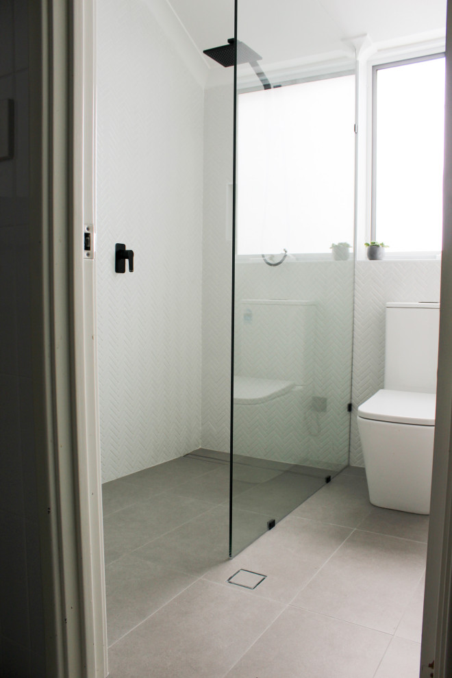 Small modern shower room bathroom in Perth with freestanding cabinets, dark wood cabinets, a walk-in shower, a one-piece toilet, white tiles, ceramic tiles, white walls, porcelain flooring, a vessel sink, wooden worktops, grey floors, an open shower and brown worktops.