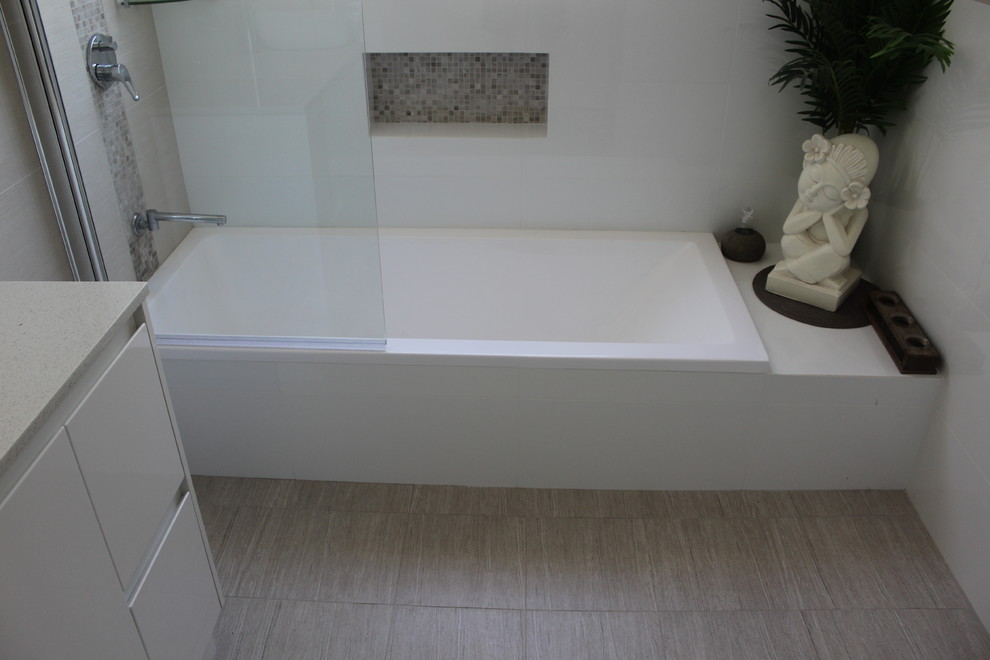 Example of a large minimalist master white tile and ceramic tile porcelain tile and gray floor bathroom design in Perth with open cabinets, white cabinets, white walls, a vessel sink, quartz countertops and a hinged shower door