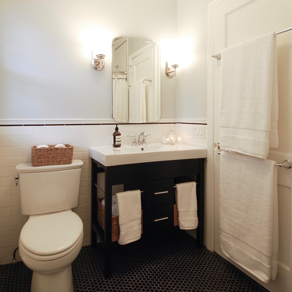 Example of a mid-sized transitional 3/4 black tile, black and white tile, white tile and subway tile ceramic tile and black floor bathroom design in New York with open cabinets, black cabinets, a one-piece toilet, gray walls, an integrated sink and quartz countertops