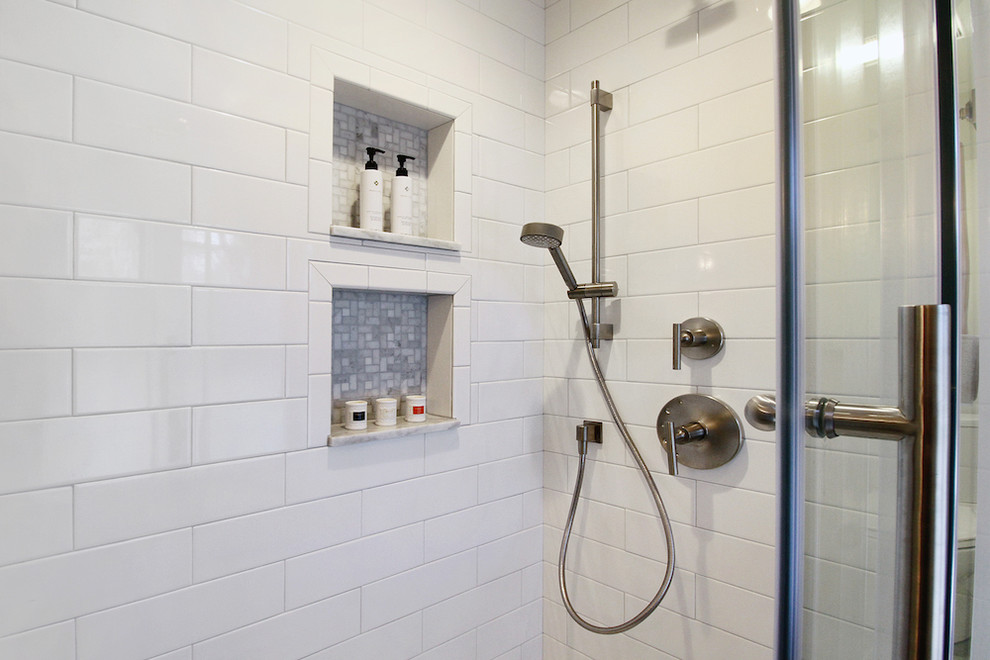 Inspiration for a medium sized modern ensuite bathroom in Providence with flat-panel cabinets, white cabinets, a corner shower, a one-piece toilet, white tiles, ceramic tiles, white walls, ceramic flooring, an integrated sink and solid surface worktops.