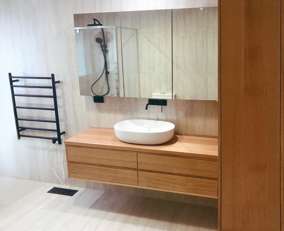 Esempio di una piccola stanza da bagno padronale contemporanea con ante in legno chiaro, WC monopezzo, piastrelle grigie, piastrelle in ceramica, pareti grigie, top in legno e pavimento grigio