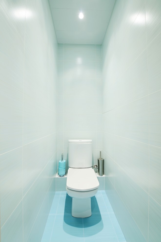 Photo of a medium sized contemporary cloakroom in San Francisco with blue walls, ceramic flooring, blue floors, flat-panel cabinets, white cabinets, blue tiles, ceramic tiles and a wall-mounted sink.