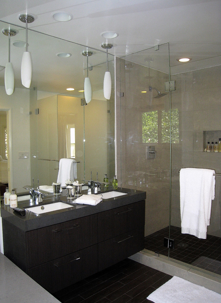 Inspiration for a mid-sized contemporary master gray tile and porcelain tile porcelain tile corner shower remodel in Los Angeles with an undermount sink, flat-panel cabinets, dark wood cabinets, solid surface countertops, an undermount tub and gray walls