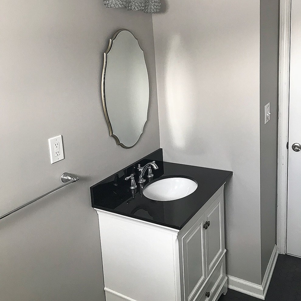 This is an example of a medium sized modern bathroom in New York with white cabinets, white tiles, metro tiles, grey walls and ceramic flooring.
