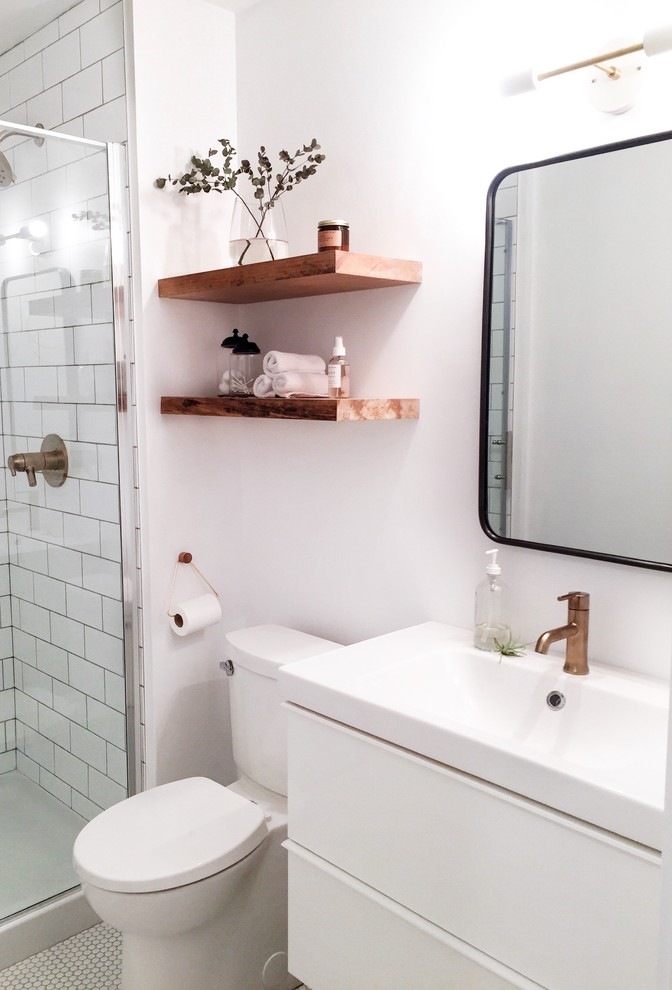 Photo of a small scandinavian shower room bathroom in Vancouver with a corner shower, white tiles, metro tiles, white walls, ceramic flooring, white floors and a hinged door.
