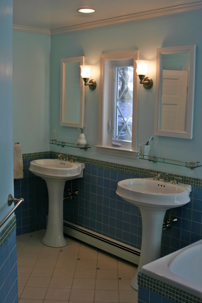 Design ideas for a small classic ensuite bathroom in New York with blue tiles, green tiles, multi-coloured tiles, blue walls, ceramic flooring, a pedestal sink, open cabinets, dark wood cabinets, a corner bath, an alcove shower, a one-piece toilet, porcelain tiles and solid surface worktops.